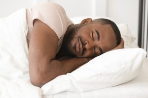 A man sleeps peacefully after seeking treatment for sleep apnea and alcohol